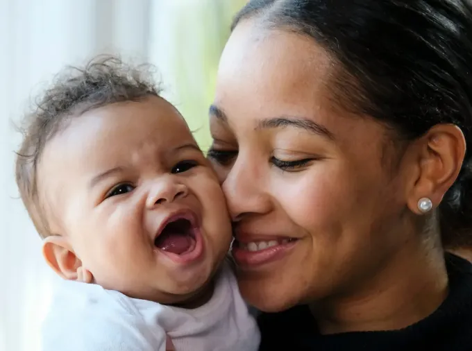 Mother nuzzling a baby.